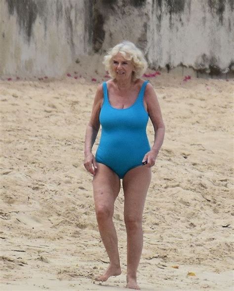 An Older Woman In A Blue Swimsuit On The Beach