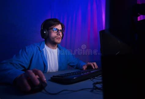 Professional Gamer Playing In First Person Shooter Video Game Stock