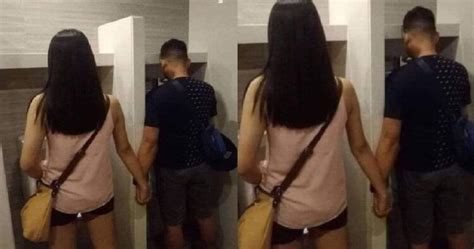 Loving Couple Hold Hand And Pee Together In Toilet Urinal Nestia