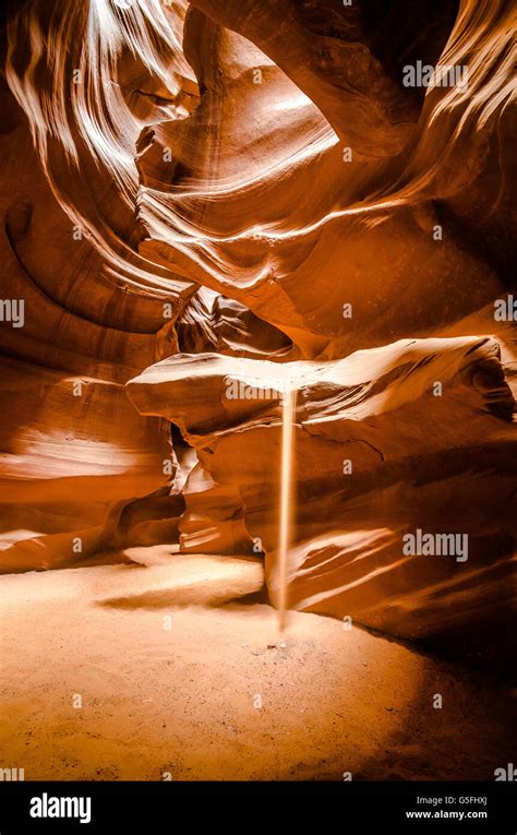 Sun Hitting The Sand Falling From A Cliff In Antelope Canyon Arizona
