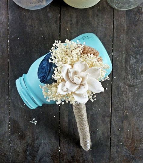 Statue of a woman carrying flowers. 10 Ideas for Mother of the Bride Flowers - EverAfterGuide
