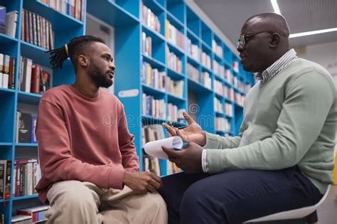 African American Male Therapist Talking To Student In Mental Health