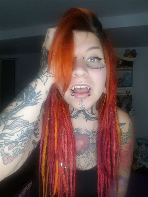 inked women with vampire fangs and dreads body modifications body mods face tattoos