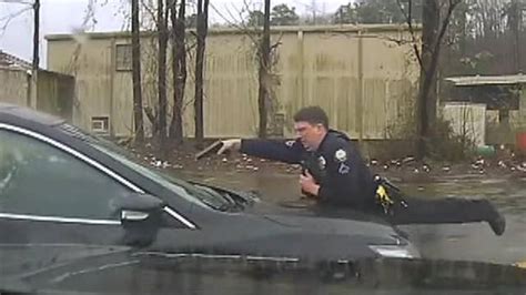 Arkansas Police Officer On Hood Of Car Fires At Driver Through