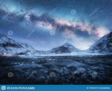 Milky Way Above Snow Covered Mountains And Stones Beach In Winter Stock
