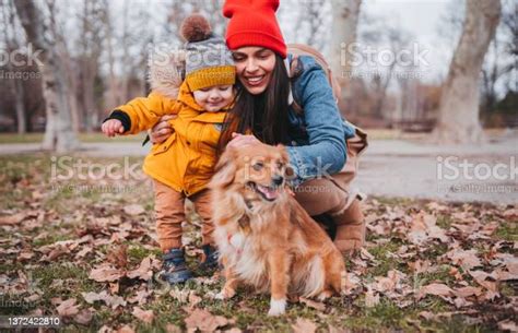 Mom Baby Boy And Dog In The Park Stock Photo Download Image Now