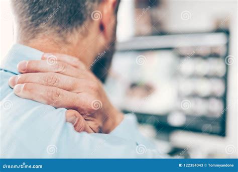 Office Worker With Neck Pain From Sitting At Desk All Day Stock Image
