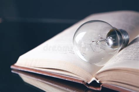 Knowledge And Wisdom Light Bulb On The Book Stock Photo Image Of