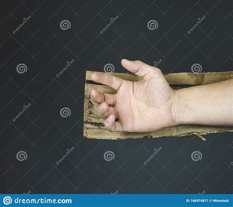 Hand Of Jesus Christ On A Wooden Cross Before Being Nailed