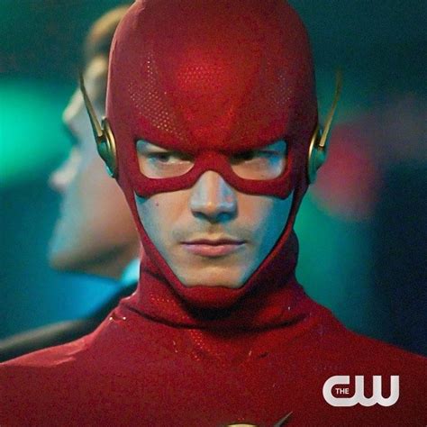 The Flash Standing In Front Of Another Man With His Head Turned To Look Like He Is Wearing