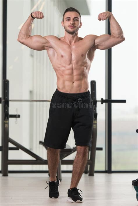 Muscular Man Flexing Muscles In Gym Stock Photo Image Of Building
