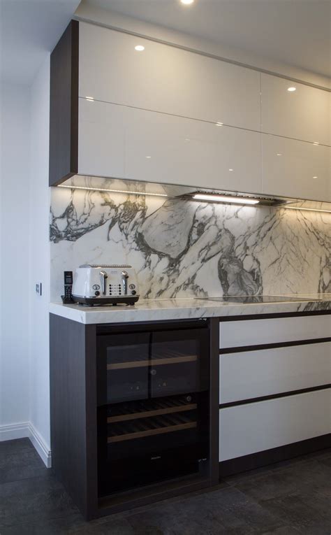 A Modern Sophisticated Handle Less Kitchen With Marble Benchtop And