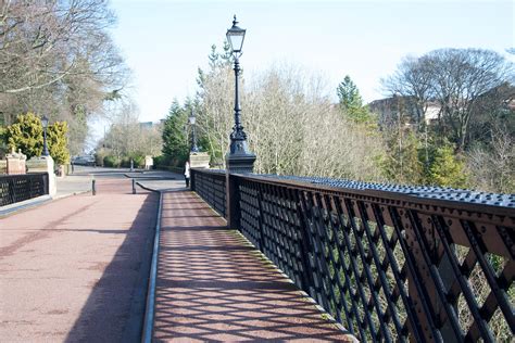 A Street Light Sitting On The Side Of A Bridge