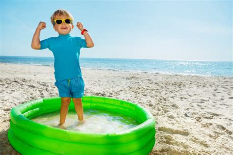 Cute Blond Boy Stand Playing Inflatable Pool In Sunglasses Stock Photo