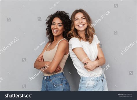 Portrait Two Cheerful Young Women Standing Stock Photo 1097067203
