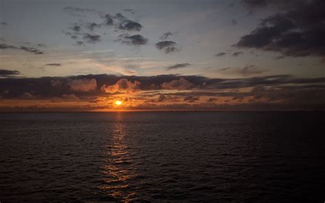 Download Wallpaper 3840x2400 Sea Horizon Clouds Sun Sunset Dark 4k