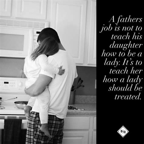A Father Is Holding His Daughter In The Kitchen