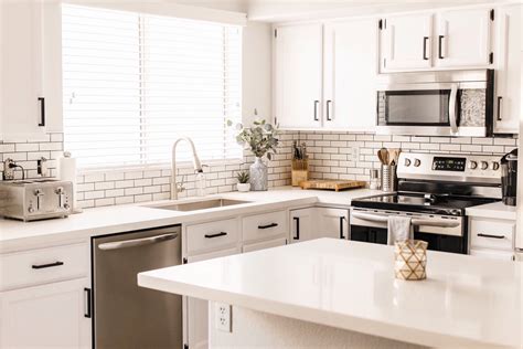 The white quartz countertop is a modern feature that feels retro thanks to its speckled pattern. 15 Modern White Kitchens