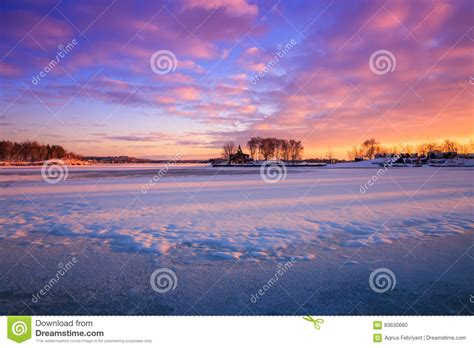 View Of A Frozen Lake During Sunrise In Winter Season Stock Photo