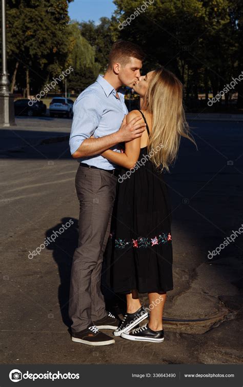 Man Kisses A Girl On The Street Hugging Her Attracted To Each Other
