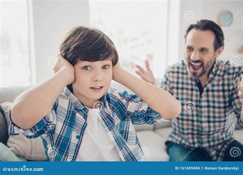 Close Up Portrait Of Two Guys Evil Outraged Aggressive Dad And Scared Pre Teen Son In Casual