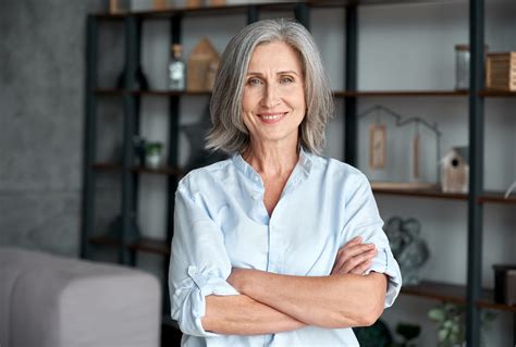 Smiling Confident Stylish Mature Middle Aged Woman Standing At Home