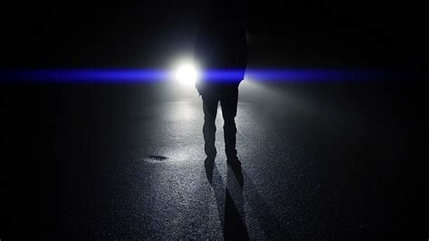 Mystical Silhouette Of Man Walking Towards Camera In Dark Night Light
