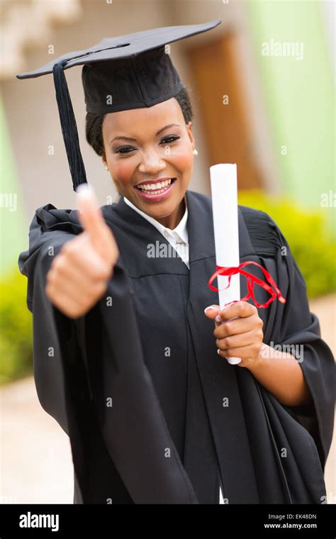 African American Female Graduate Thumb Up Outside College Building