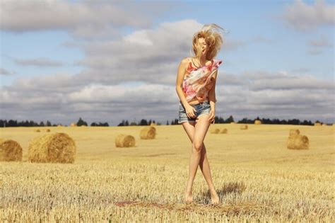 Premium Photo Beautiful Blonde Jumps In Sloping Field Sun Happiness