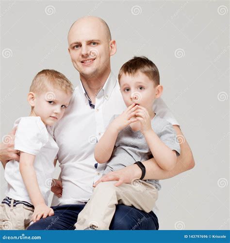 Father And His Two Sons The Young Man Raising Children The Concept