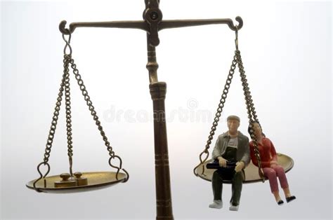 Man And Woman Sitting On Golden Weighing Scale Stock Photo Image Of
