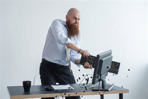 Angry Bald Man With A Red Beard In The Office In A Business Suit