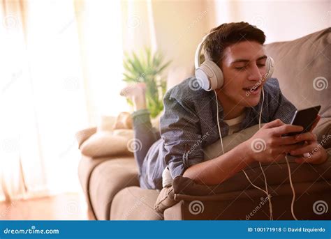 Teen Singing And Listening Music With Headphones Lying Face Down Stock