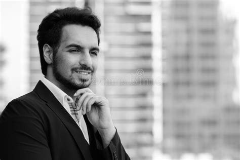 Young Happy Indian Businessman Smiling And Thinking At Rooftop Against