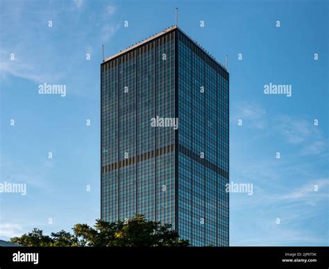 Tall Skyscraper Exterior In Front Of A Blue Sky Modern Facade With A