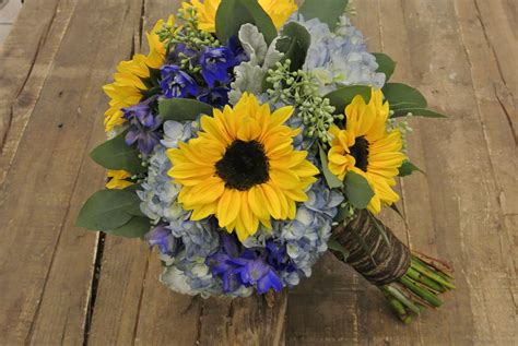 blue and yellow bridal bouquet with sunflowers hydrangea delphinium seeded eucalyptus dust