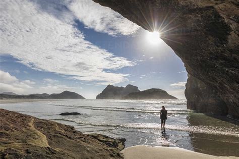 New Zealand South Island Tasman Tourist In Cave On Wharariki Beach