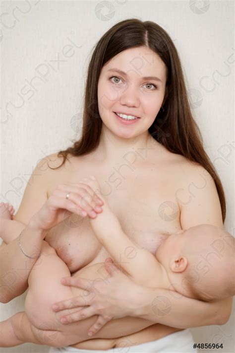 A Naked Mother Feeds The Baby With Breast Milk The Stock Photo