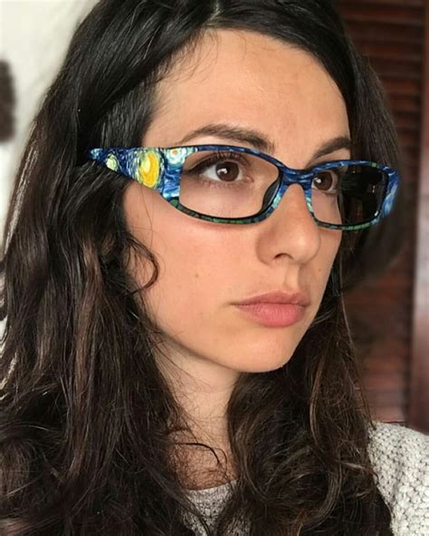 A Woman Wearing Glasses With Flowers On Them