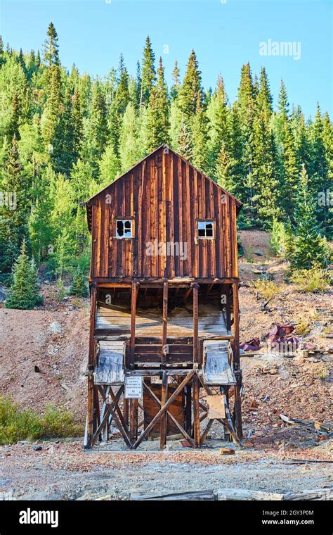 Old Empty Log Mining Structure With Wall Of Mountains Stock Photo Alamy