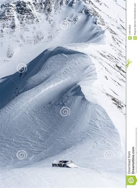 Snow Covered Mountain Ridge Leading Down To Alpine Hut Stock Image