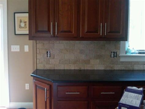 Not only will it have a naturally worn finish, but tumbled stones tend to be. dark counters, tumbled travertine backsplash... love stone ...