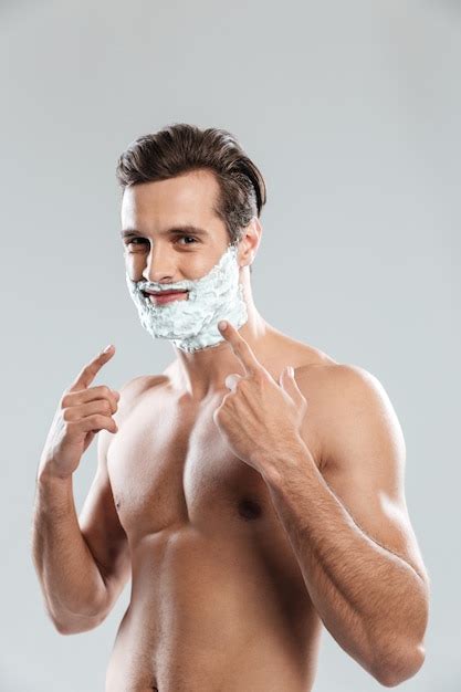 Free Photo Young Attractive Man With Shaving Foam On Face Pointing