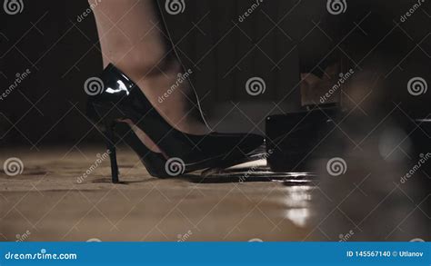 Close Up Of Female Legs In Shoes Pressing On The Pedal Piano Stock