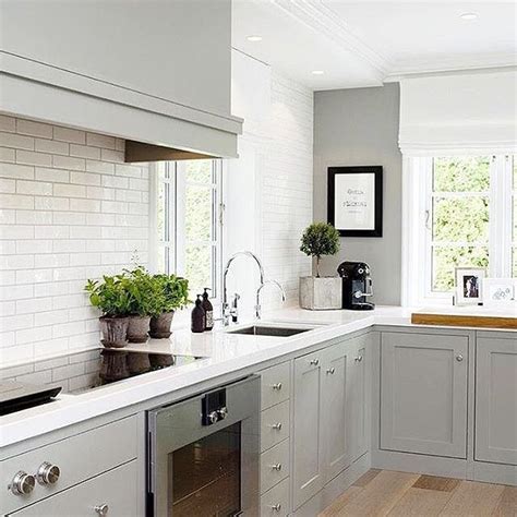 Another popular trendy color for kitchen cabinets is mindful gray sw 7016. A soft gray & white color combo makes a beautiful space in this kitchen design by @collinedesign ...