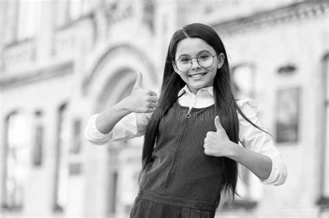 Happy Child In School Uniform Give Thumbs Ups Hand Gesture In