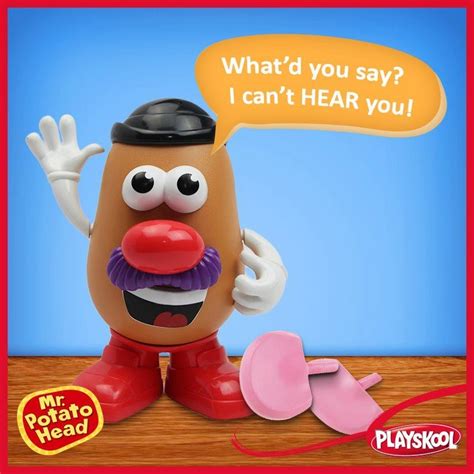 a potato head with a hat and mustache on it s head is sitting next to a pair of pink slippers