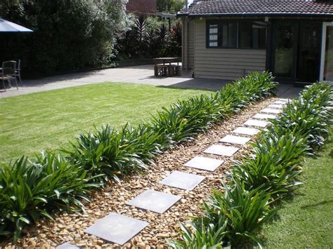Modern walkway design with concrete pavers and la paz pebbles photo of a small modern back xeriscape partial sun garden in san francisco. The path to the back of the house after laying pavers and ...