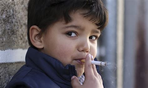 Children Smoke Cigarettes As Village Celebrates Epiphany