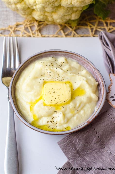 A Bowl Filled With Mashed Potatoes And Butter On Top Of A White Place Mat